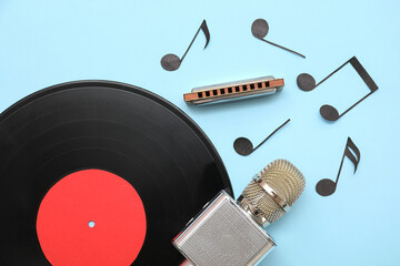 Composition with harmonica, microphone, vinyl disk and music notes on color background