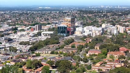 Low aerial drone view of the east side of Bankstown cbd in Sydney NSW, Australia looking from above...