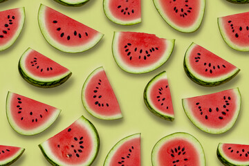 Fresh watermelon slices on light green background