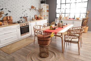 Interior of kitchen decorated for Halloween with white counters and dining table