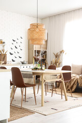 Interior of kitchen decorated for Halloween with dining table and sofa