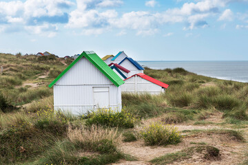 White beach huts with colourful roofs at Gouville-sur-Mer in Normandy, France