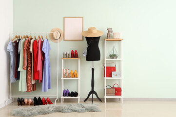 Interior of dressing room with mannequin, clothes rack and shelf units