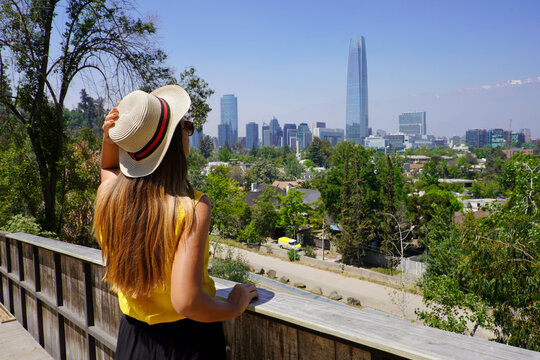 Young tourist woman enjoying Santiago de Chile skyline from terrace, Santiago, Chile