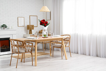 Vase with beautiful dahlias on dining table in living room