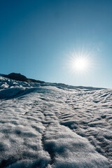 Glacier hike expedition during sunny day with blue sky on the Vatnajokull national park on Iceland 