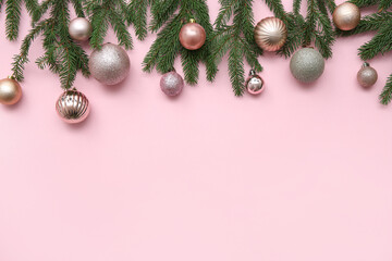 Composition with Christmas balls and fir branches on pink background