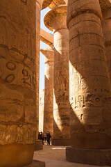 Karnak, Luxor, Egypt - 9 February 2022: Tourists and Columns of the Great Hypostyle Hall at the Karnak Temple complex in Luxor