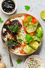 Rice bowl with teriyaki fish fillet and fresh crispy vegetables.top veiw