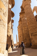 Karnak, Luxor, Egypt - 9 February 2022: Tourists and Columns of the Great Hypostyle Hall at the Karnak Temple complex in Luxor