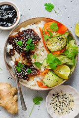 Rice bowl with teriyaki fish fillet and fresh crispy vegetables.top veiw