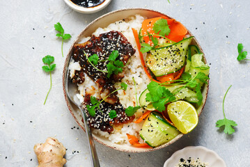 Rice bowl with teriyaki fish fillet and fresh crispy vegetables.top veiw