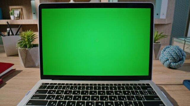 Hand browsing website greenscreen laptop at home closeup zoom in. Unknown man