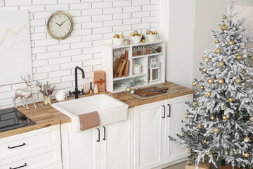 Interior of kitchen with counters and Christmas tree