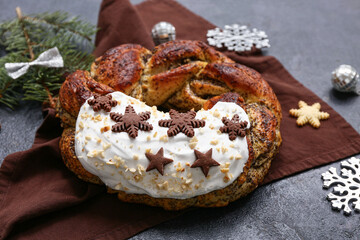 Tasty Christmas pastry wreath and decorations on dark background