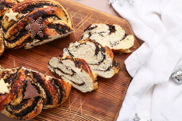 Wooden board with tasty Christmas pastry wreath and napkin, closeup