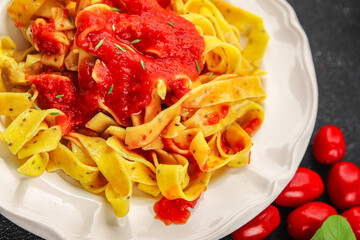 Pasta tagliatelle tomato sauce tasty food dish fresh delicious gourmet food background on the table...