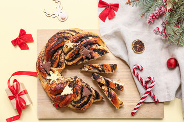 Composition with tasty Christmas pastry wreath and beautiful decorations on color background