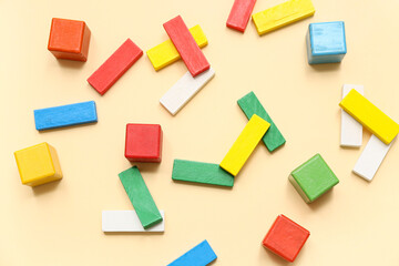 Different colorful building blocks on color background