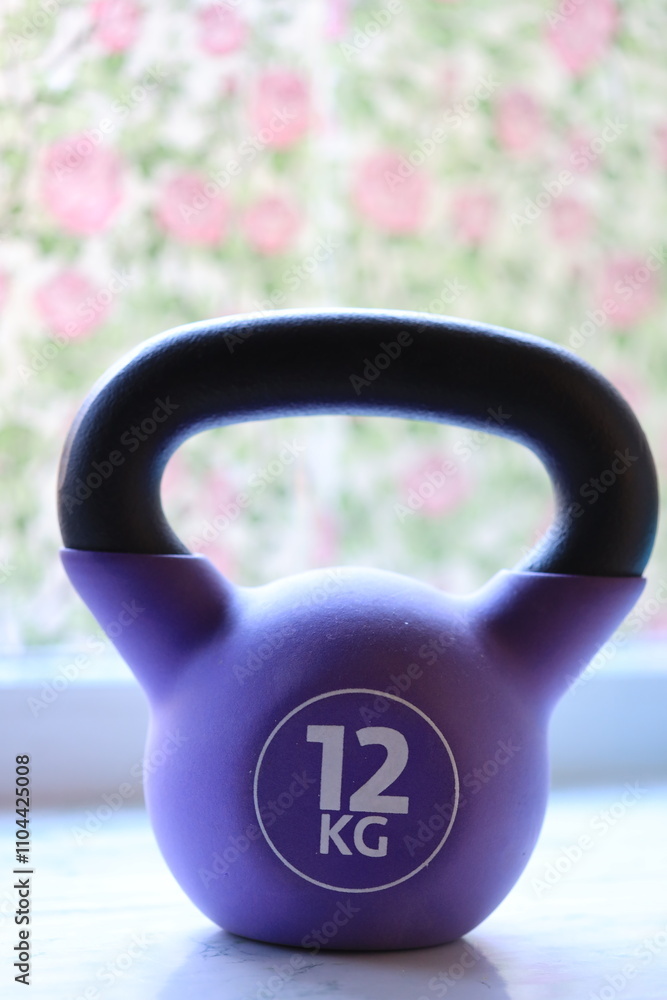 Poster a close-up shot of a kettlebell resting on a window sill, ready for use.