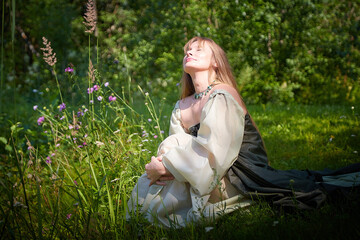 Beautiful dryad or fairy in nature. Pagan spirit of forest. Environmental friendliness and caring...