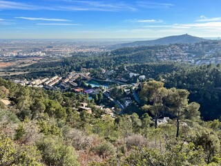 view of the populated and hilly landscape by the sea near Barcelona