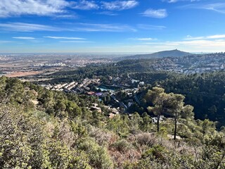 view of the populated and hilly landscape by the sea near Barcelona