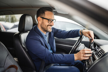 Adult businessman sit in the car and go to work