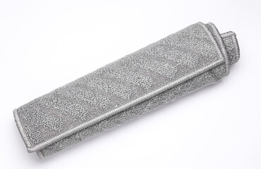 Roll of gray rug on white background