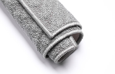 Roll of gray rug on white background