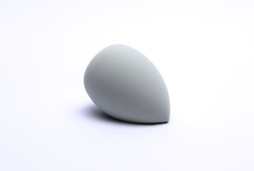 Egg makeup sponge. Blender for foundation on white background