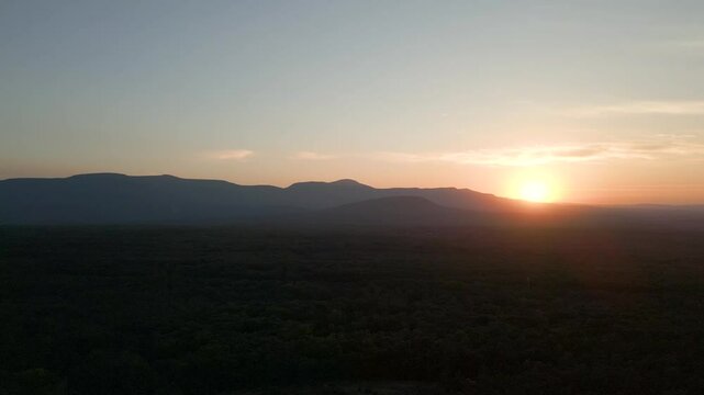 Beautiful golden hour landscape over the mountains, drone 4K