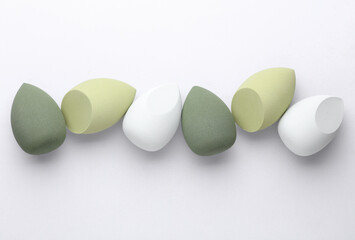 Set of Eggs makeup sponges. Blenders for foundation on gray background. Top view. Beauty concept