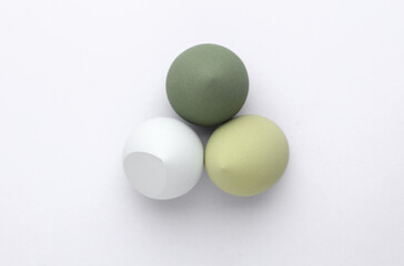Set of Eggs makeup sponges. Blenders for foundation on gray background. Top view. Beauty concept