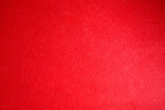 Red textured surface as background, top view