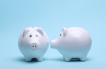Ceramic white piggy bank on a blue background. Business concept. Conceptual photo