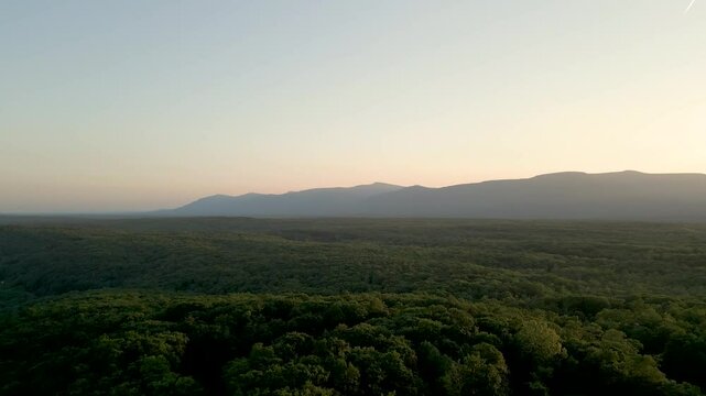 Beautiful golden hour landscape over the mountains, drone 4K
