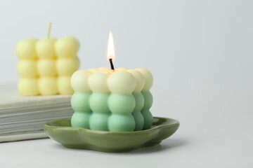 Beautiful bubble candles on light background, closeup