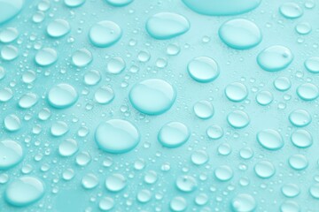 Water drops on turquoise background, closeup view