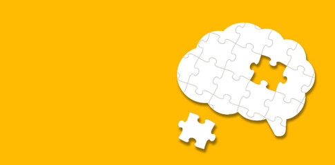 Brain shaped white jigsaw puzzle on yellow background. A missing piece of the brain puzzle. Mental...