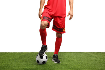 Football player with soccer ball on artificial grass against white background, closeup
