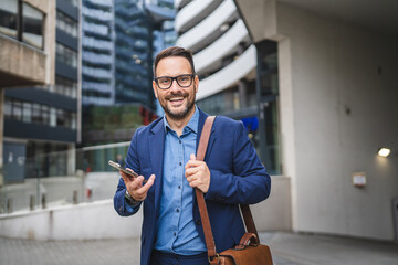businessman walk around city and use mobile phone