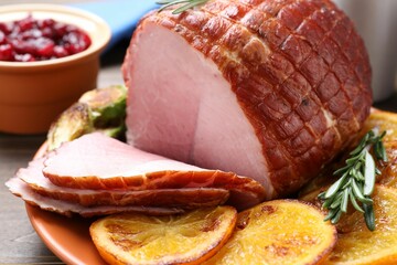 Christmas food. Tasty baked ham served on wooden table, closeup