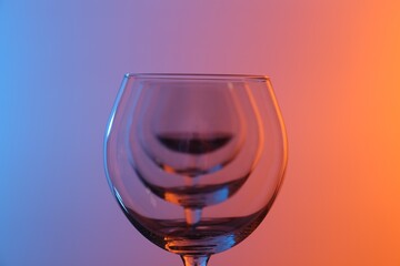 Wine glasses on color background, closeup view