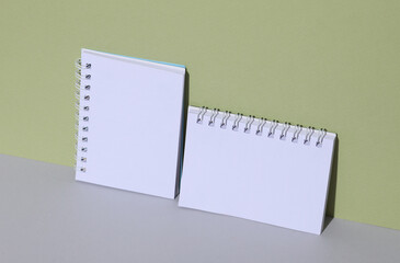 White notebooks on a green background