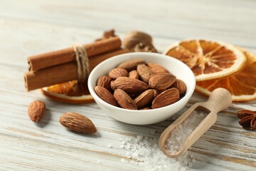 Different spices and dried orange slices on white wooden table, closeup. Christmas season