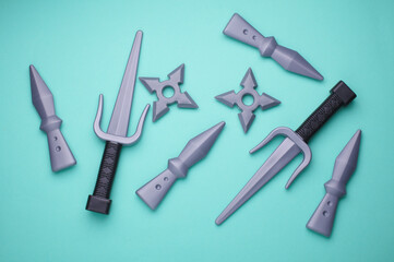 Children plastic toy ninja weapon on blue background. Top view © splitov27