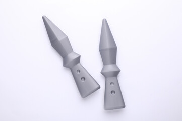 Toy ninja throwing weapons on white background