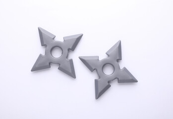 Toy plastic ninja shurikens on white background © splitov27