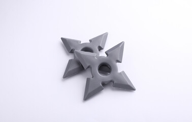 Toy plastic ninja shurikens on white background © splitov27